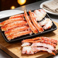 King crab legs on a black tray